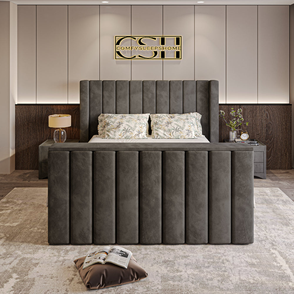 A modern grey 2025 Lynza TV Bed with a tall, channel-tufted headboard and matching footboard, set in a stylish bedroom.