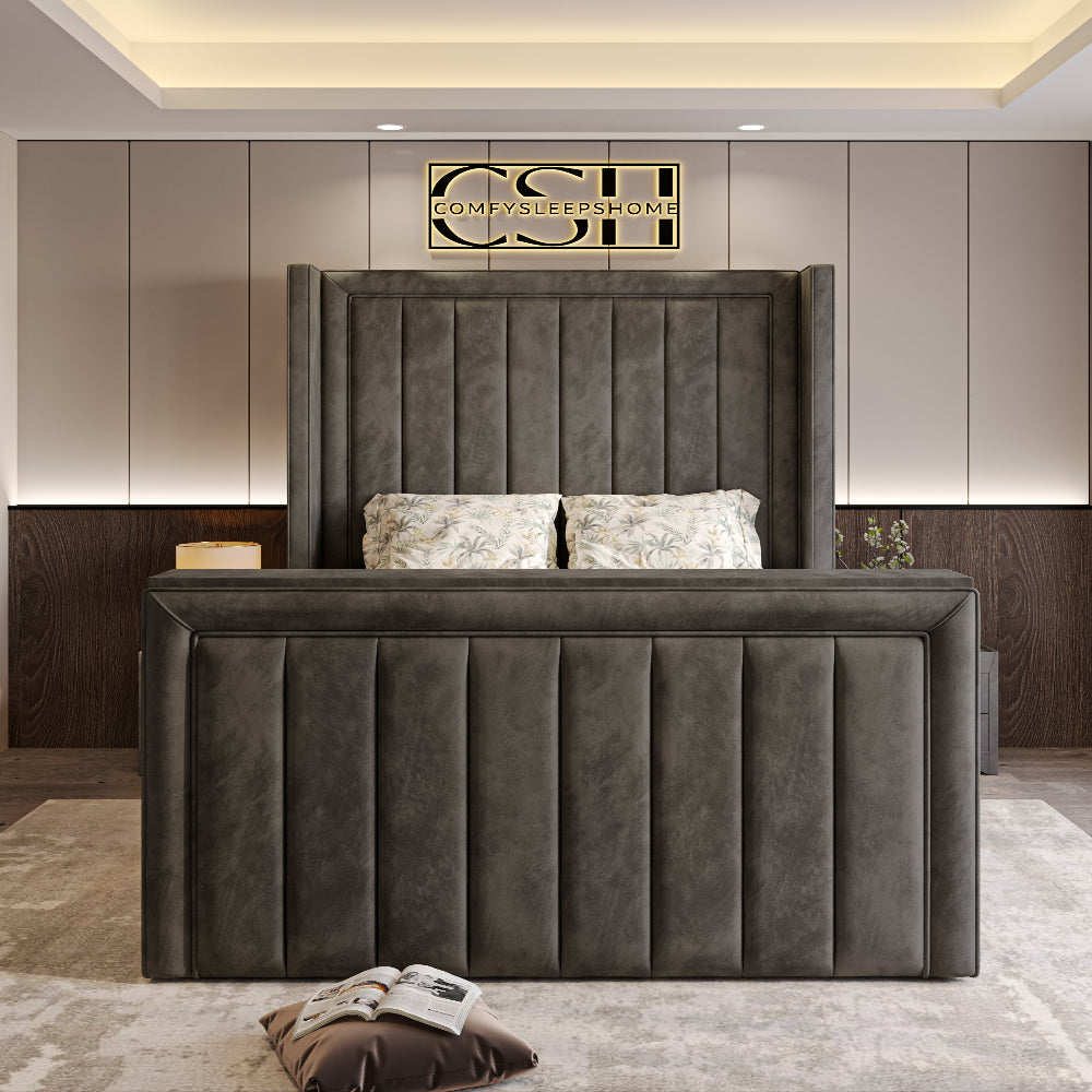 A majestic grey 2025 The Astoria TV Bed with a tall, panelled headboard and a grand, vertically-ribbed footboard in a contemporary bedroom.