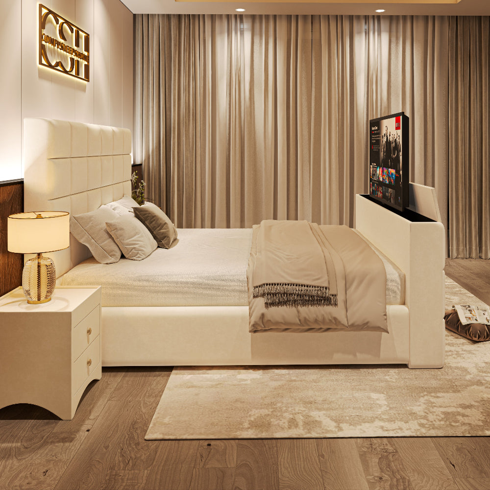 An elegant white upholstered 2025 The Cubix TV Bed with a ribbed headboard and pop-up TV, in a contemporary bedroom setting.