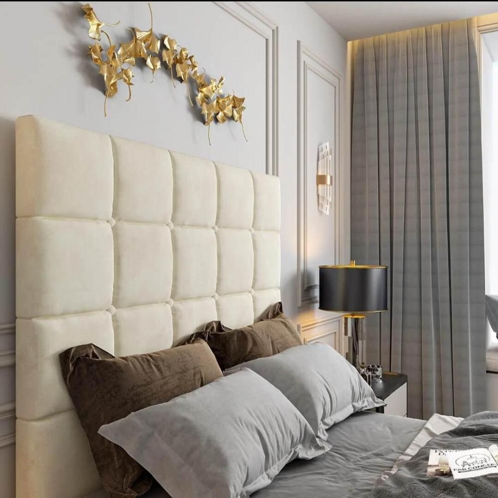 Luxurious bedroom with a creamy white tufted windsor Tv Bed headboard, gray bedding, gold decorative wall art, and a black lamp on a nightstand.