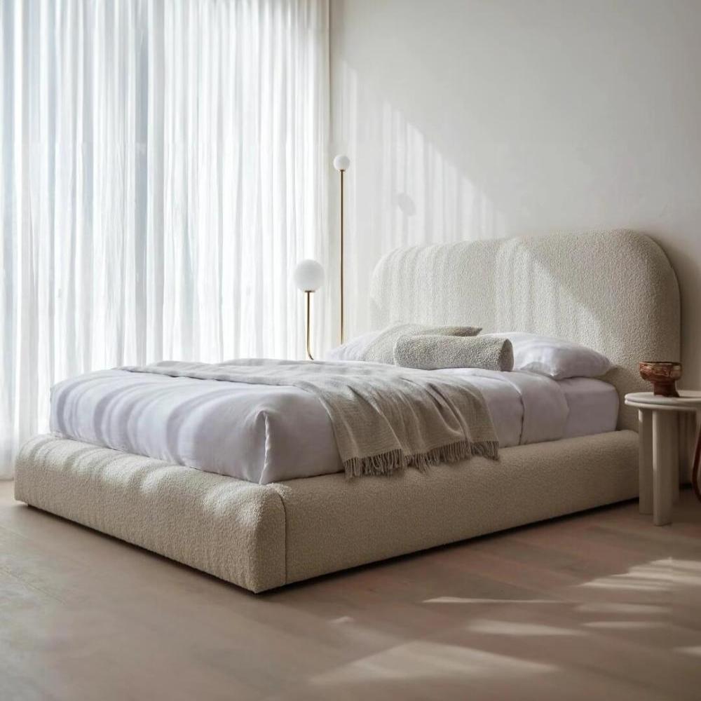 Modern bedroom with Double Wooden Bed, light beige fabric, white linens, and minimalist decor.