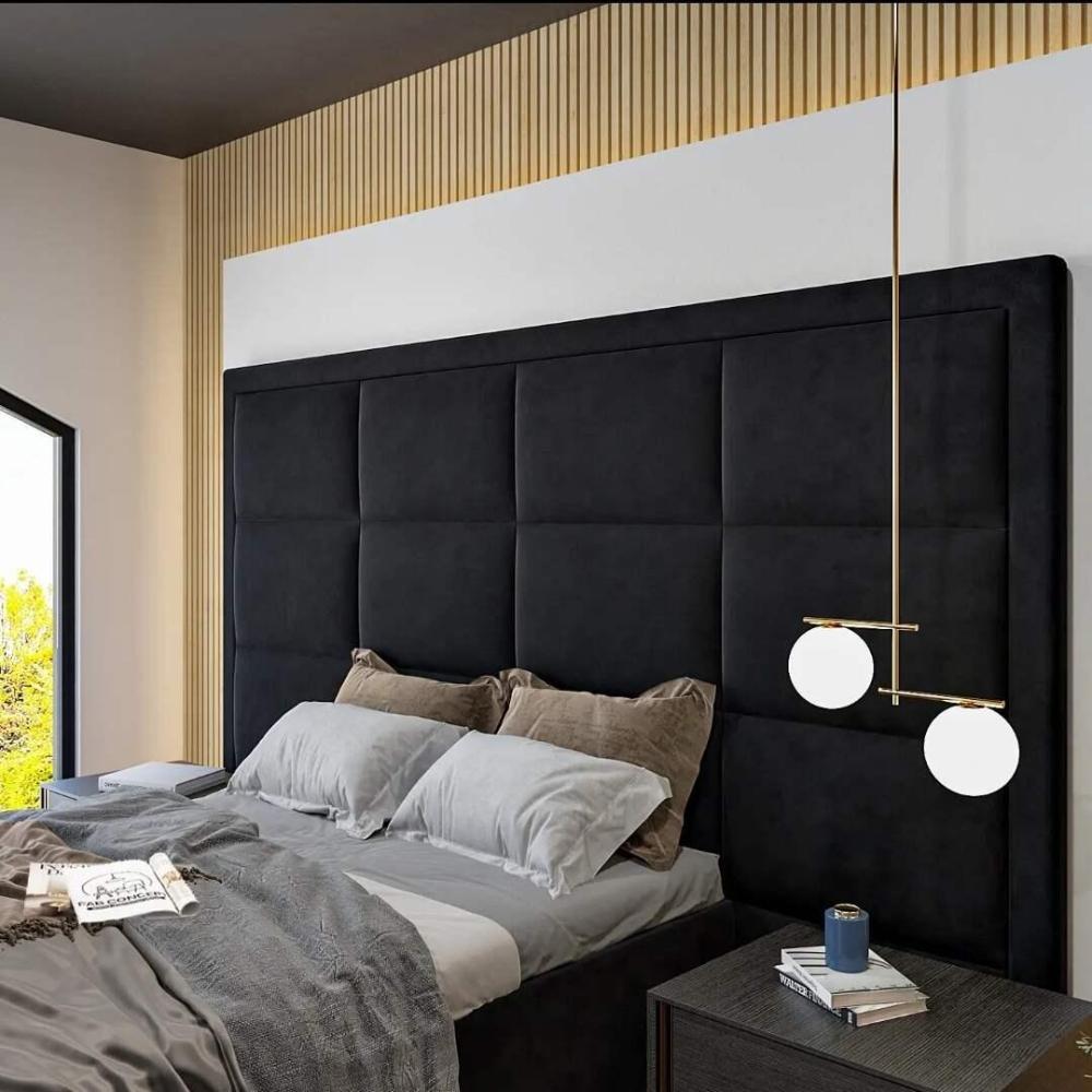 Bedroom with a high bed frame and black headboard, gray and beige bedding, a modern nightstand, and a hanging light fixture.