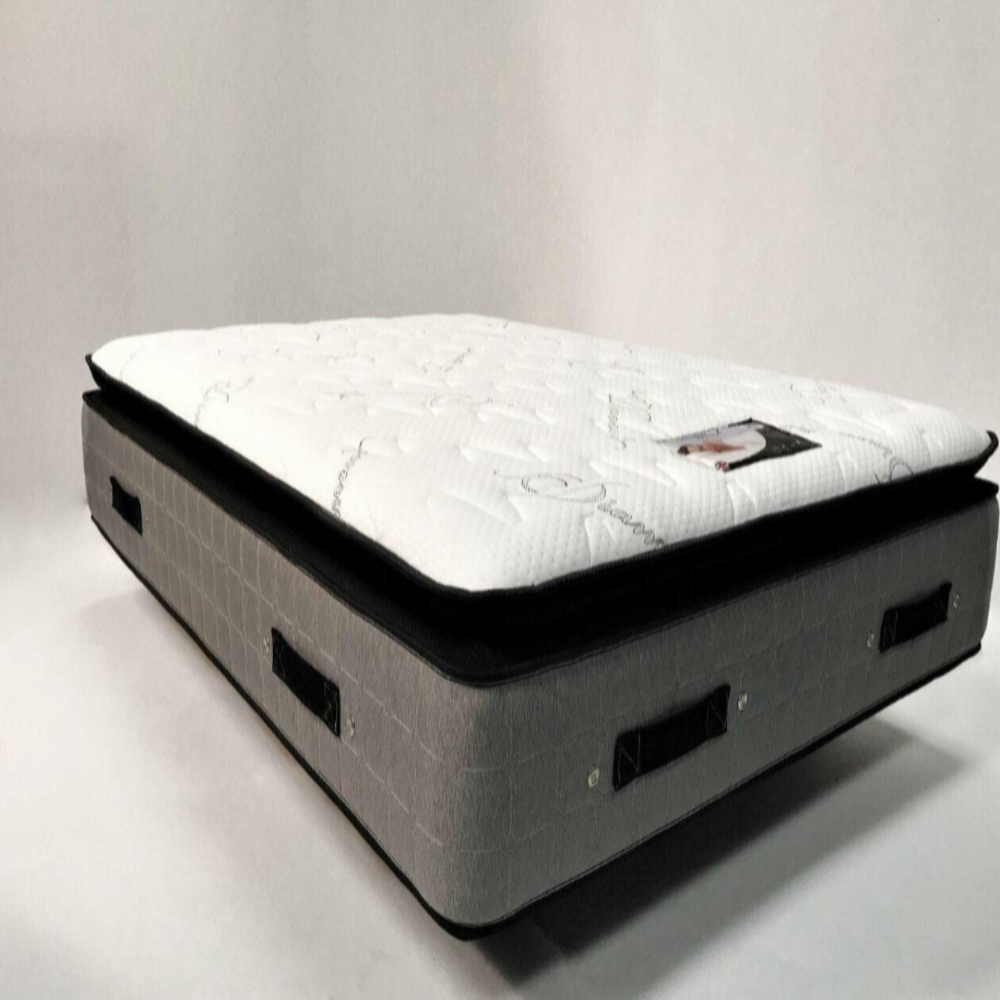 King size mattress with a plush white top layer and a gray base featuring black handles.