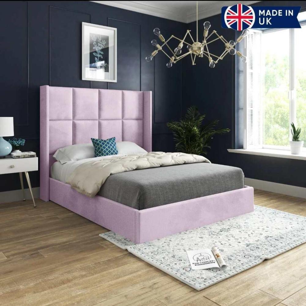 A bedroom featuring a light pink bed frame in a single bed frame size, with a geometric chandelier and navy walls; Made in UK.