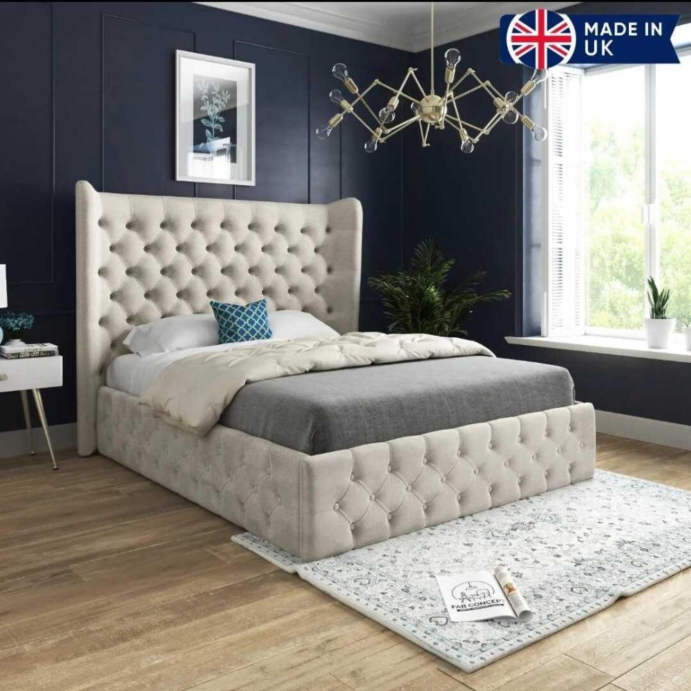 Bedroom with large tufted single divan bed and blue walls.