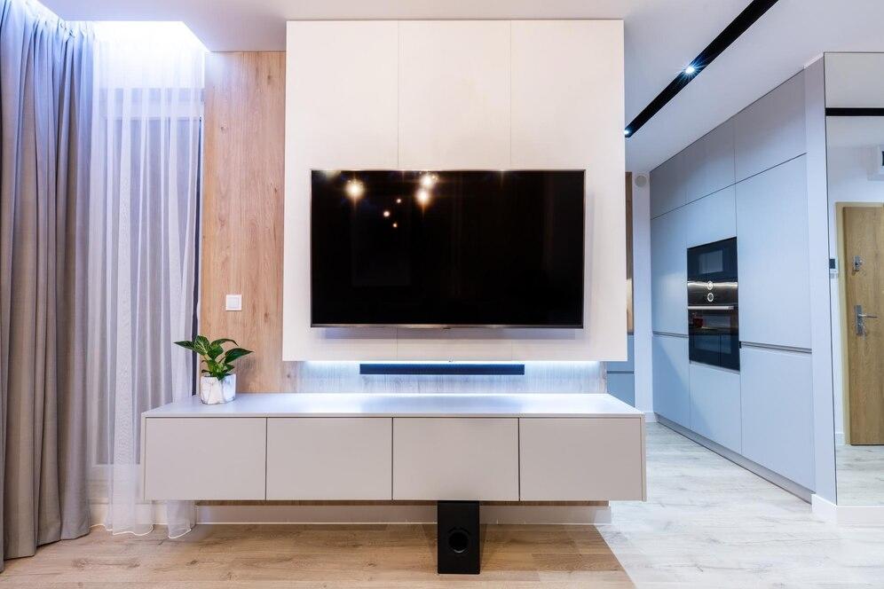 Modern living room with TV lift cabinet and sleek decor.