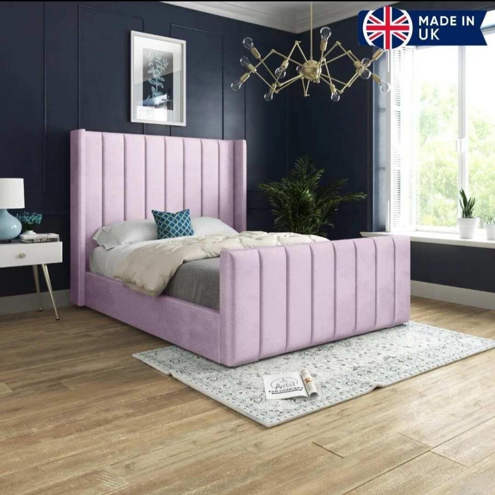 Victorian-style bed with a pink tufted headboard in a navy blue room.