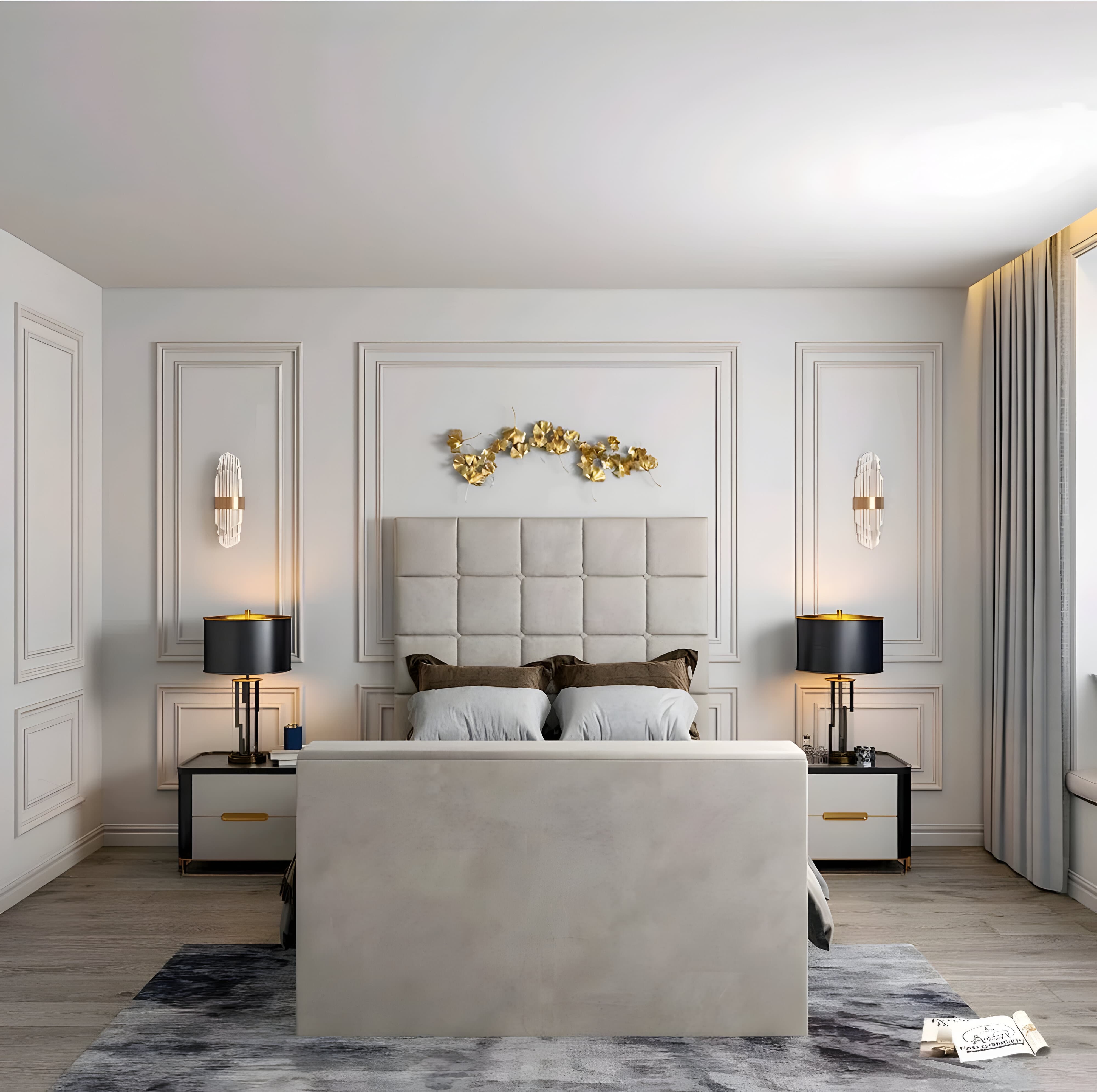 A bedroom with a cream bed frame and tufted headboard, flanked by black lamps on nightstands. Gold wall art above the headboard.
