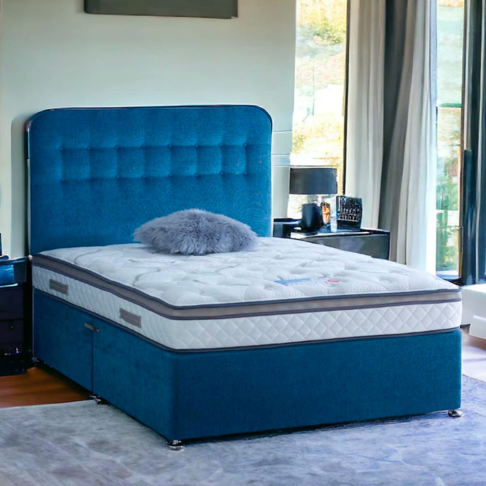 A king-size bed with a blue upholstered headboard and a white king size mattress in a modern bedroom.