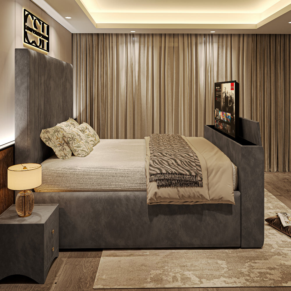 A stylish grey upholstered 2025 Belgravia TV Bed with a tall headboard, integrated TV, and bedside table in a modern bedroom.