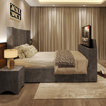 A luxurious grey upholstered 2025 Lynza TV Bed with a fluted headboard and built-in television, in a chic bedroom.