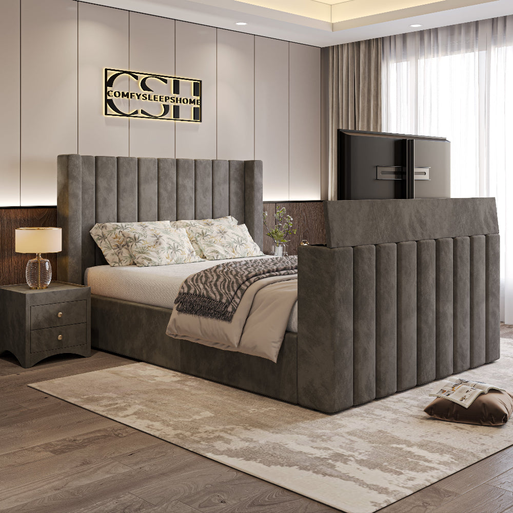 A luxurious grey 2025 Lynza TV Bed with a tall, channel-tufted headboard and integrated TV, complementing a modern bedroom interior.