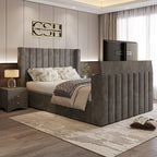 A luxurious grey 2025 Lynza TV Bed with a tall, channel-tufted headboard and integrated TV, complementing a modern bedroom interior.