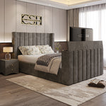 A luxurious grey 2025 Lynza TV Bed with a tall, channel-tufted headboard and integrated TV, complementing a modern bedroom interior.
