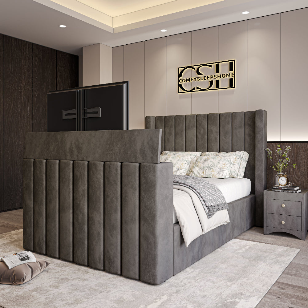 A modern grey upholstered 2025 Lynza TV Bed with a tall, channel-tufted headboard and a pop-up TV, in a contemporary bedroom setting