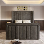 
A majestic grey 2025 The Astoria TV Bed with a tall, panelled headboard and a grand, vertically-ribbed footboard in a contemporary bedroom.