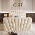 A sophisticated cream 2025 The Chelsea TV Bed with a panelled, winged headboard and a grand, vertically-ribbed footboard in a chic bedroom.