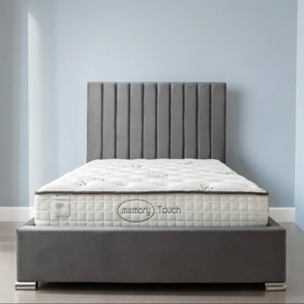 A modern bed with a Memory Touch mattress and a dark gray upholstered frame. Main image