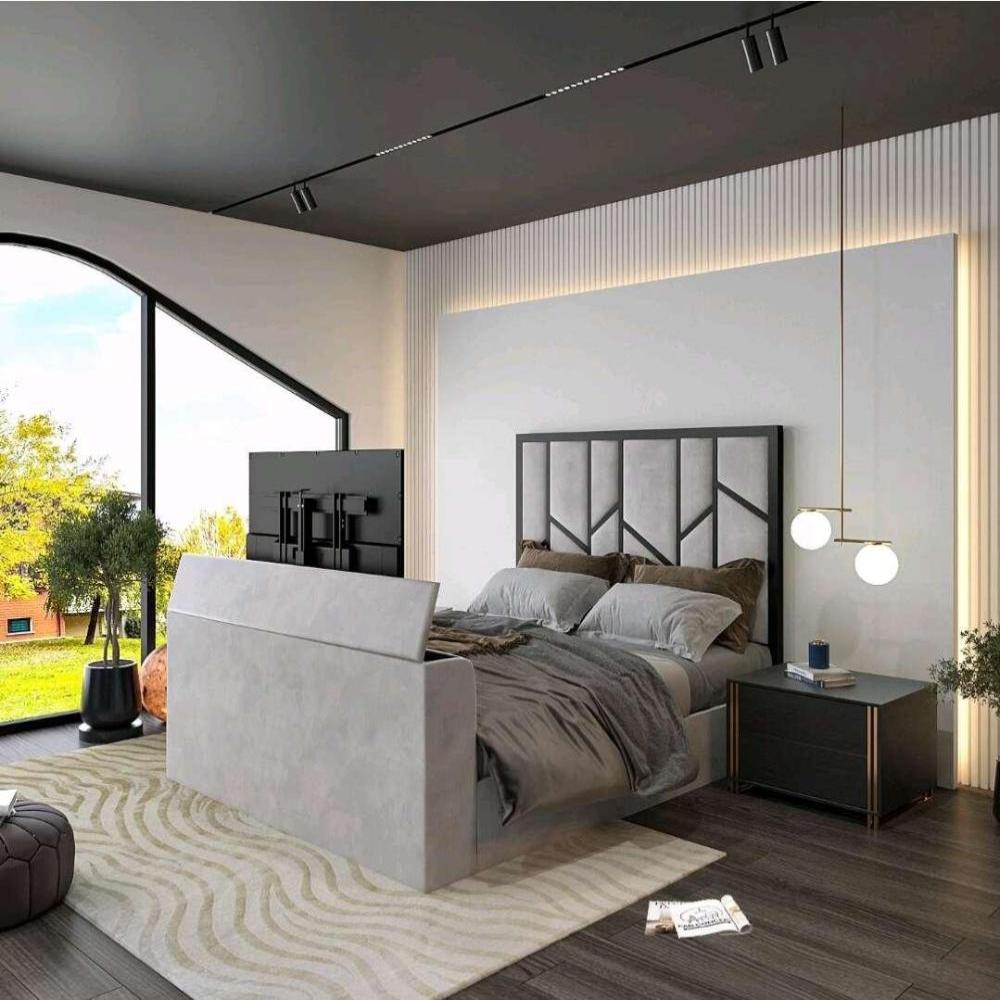 Modern bedroom with a gray upholstered Zig Zag Tv bed, flat-screen TV, black nightstand, and large window view of greenery.

 Main image